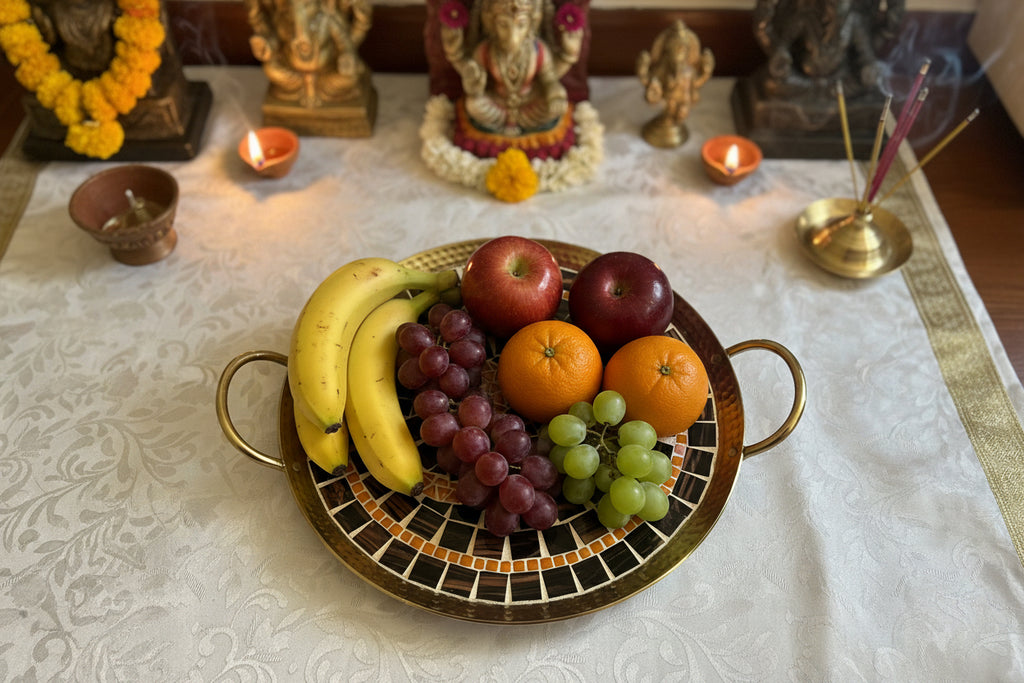 Decorative tray with mosaic design and gold trim on a textured white background